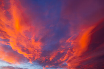 Dramatic orange clouds at sunset. Cloudscape with amazing clouds.