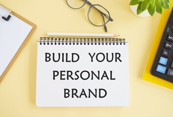 Build your brand typed on yellow paper on top of computer keyboard.