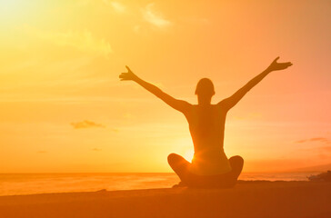 woman enjoying the beautiful sunrise feeling joyful with open arms	