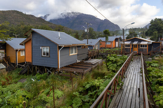 Small colorful houses and nalca plants along the wooden paths of Tortel, Patagonia, Chile