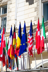 Many flags of the world on the facade of a historic building