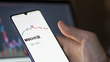 Investor analyzing an ETF. Funds stocks exchange ETFs Japanese text: msci usa, buy. MSCI米国 証券取引所 投資 shares