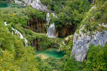 Fototapeta premium Plitvice, Croatia: View of the beautiful waterfalls of Plitvice Lakes in Plitvice National Park. Green foliage and turquoise water