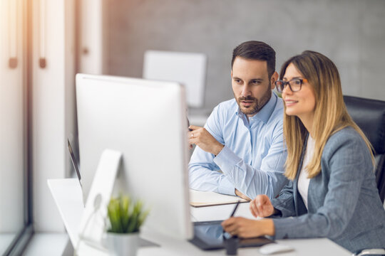Two coworkers at the office discuss about business strategy of new investments