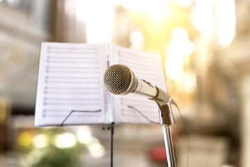 Religious songs with microphone and music stand in church - obrazy, fototapety, plakaty