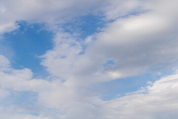 Clouds in the blue sky as a background for multiple applications