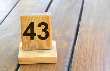 Wooden priority number 43 on a plank tab