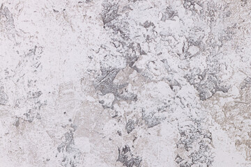 Close-up of a beautiful stone wall texture in a light gray tone with a rough surface for a modern background, interior and marble finish.