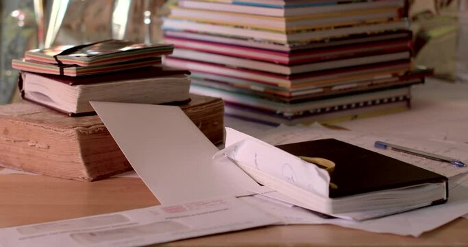 beginning of the working day, turning on the light. An old book lies on the table, a black notebook. Entries are printed in machine type.