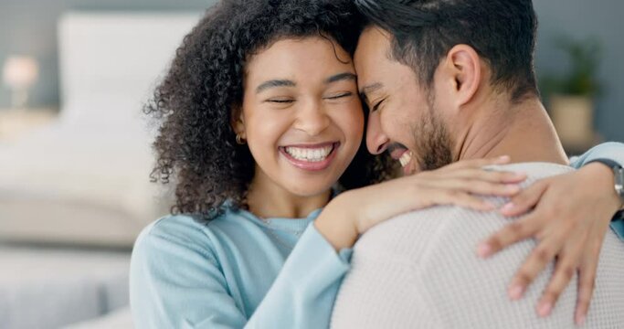 Couple, love and hug while sharing kiss, commitment and happy marriage while bonding and spending time in interracial relationship with handheld movement. Laughing man and woman celebrate anniversary
