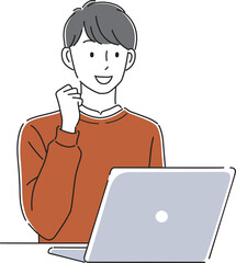 ノートパソコンの前でガッツポーズをする男性