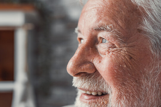 Handsome older man smiling staring at camera feels happy, close up face view. Senior advertise professional dental clinic, teeth repair and check up services, medical insurance cover for elder concept
