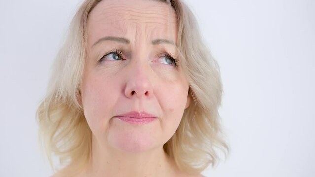 hide tears woman cries sadly looks cry without tears sighs lowers eyes shrugs shoulders trouble frustration disappointment sadness whims blonde on a white background