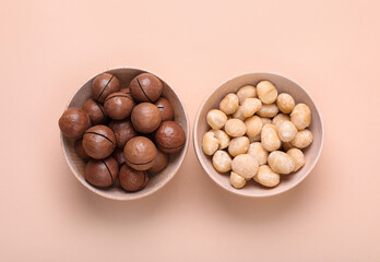Delicious organic Macadamia nuts on beige background, flat lay