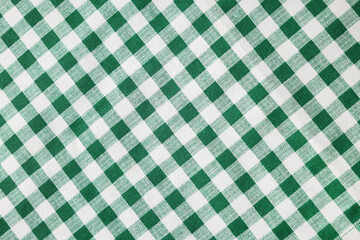 Green checkered tablecloth as background, top view