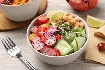 Bowl with many different vegetables on white wooden table. Vegan diet