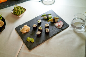 Prepared dinner in a stylish asian food restaurant. Close-up of Asian food in a dimly lit...