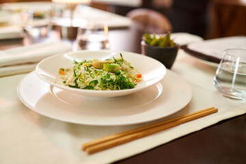 Prepared dinner in a stylish asian food restaurant. Close-up of Asian food in a dimly lit restaurant.
