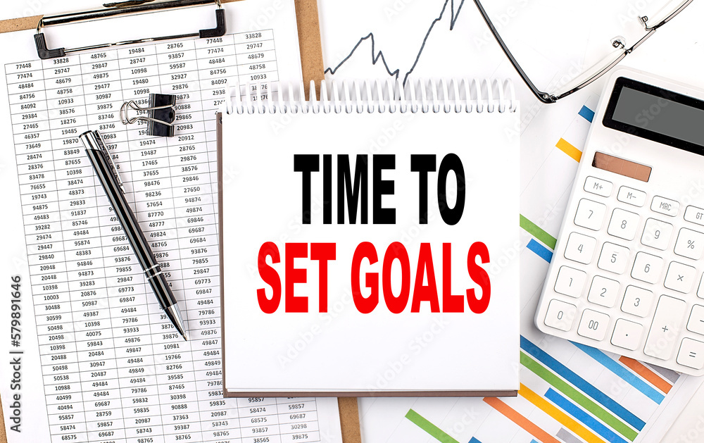 Aufkleber time to set goals text on notebook with chart, calculator and pen