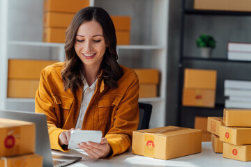   startup girl Small SME business owners work with laptop computers at work. with parcel paper...