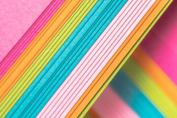 A stack of bright paper for artistic projects.