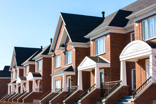 Row of red brick luxury townhouses in residential district.	
