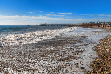 Splashes of waves break on the rocks. Sea surf on the beach. The power of water on the sea surf....