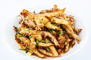 A plate of spicy chicken feet on a white background