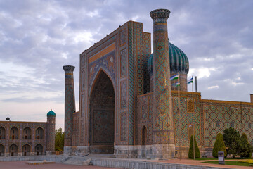 Fototapeta premium Facade of the ancient Sherdor madrasah close-up on a cloudy September evening. Samarkand, Uzbekistan