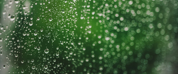 Atmospheric minimal backdrop with rain droplets on glass. Wet window with rainy drops and dirt...