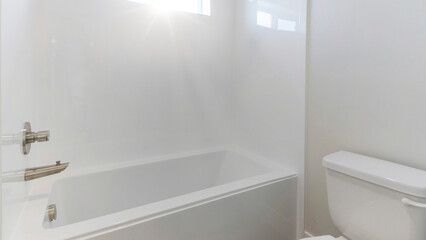 Fototapeta na wymiar Panorama Sun flare White bathroom interior with windows and gray tiles flooring