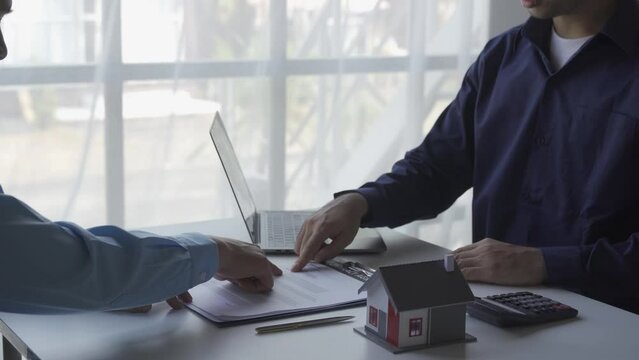 Real estate business meeting, two businessmen discussing house sale in office