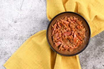 Traditional Polish dish Bigos Stew in a bowl on a dark background. Top view, flat lay