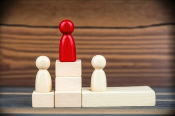 contest winner concept, wooden figures on wooden blocks, business contest winner