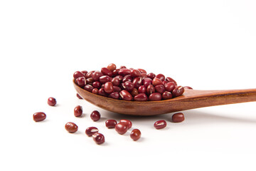 Raw red bean or azuki beans seeds on spoon isolated on white background