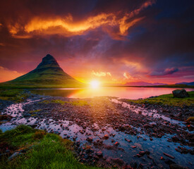 An incredible view of the famous peak of the Kirkjufell volcano at dawn. Iceland, Europe.