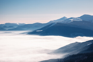 Fototapeta na wymiar Sunny frosty day in the mountains with fog in the valley. Carpathian, Ukraine, Europe.
