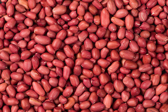 red peeled peanuts texture background.