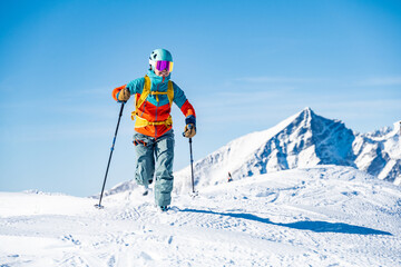 Mountaineer backcountry ski walking ski alpinist in the mountains. Ski touring in alpine landscape with snowy trees. Adventure winter sport. Tatras, slovakia