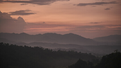 The Enchanting Beauty of an Evening Mountain View: Captured in a Yellow Sky Low-Light Photo