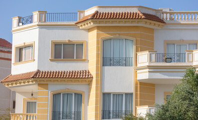 White building with windows against the  sky.