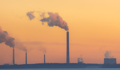 Smoke from the chimneys of a metal plant against the sky. Production.