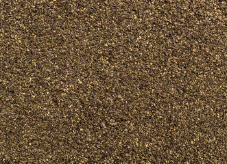 Ground pepper as natural abstract background. Top view.
