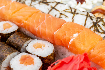 Different tasty sushi rolls. Food background.