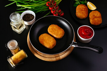 chicken cutlet. vegetables and herbs are lying side by side on t