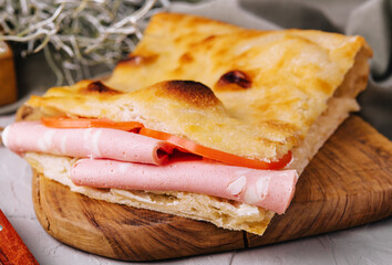 Fried pita bread with ham close up