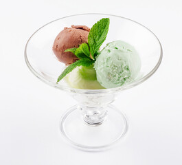 Three balls of ice cream in a transparent glass