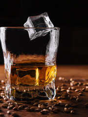 Glass of whiskey with ice and wheat