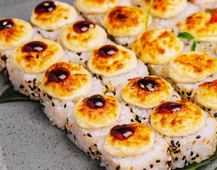 warm sushi rolls on a stone plate
