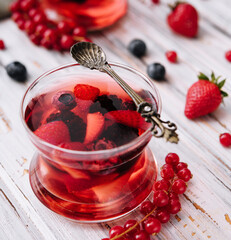 Jelly with fresh berries on wooden table close up